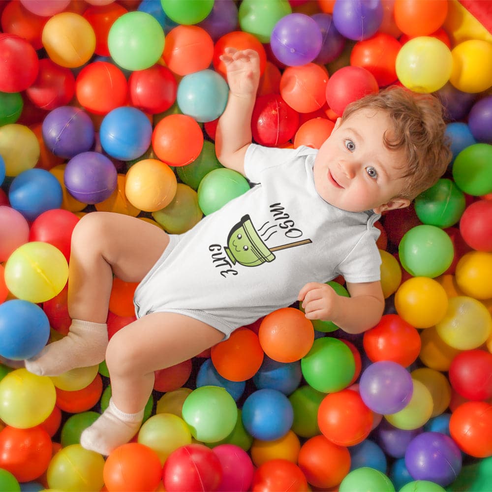 https://newbabywishes.com/cdn/shop/products/pretty-baby-boy-having-fun-at-a-ball-pit-wearing-a-onesie-mockup-14021.jpg?v=1683222241